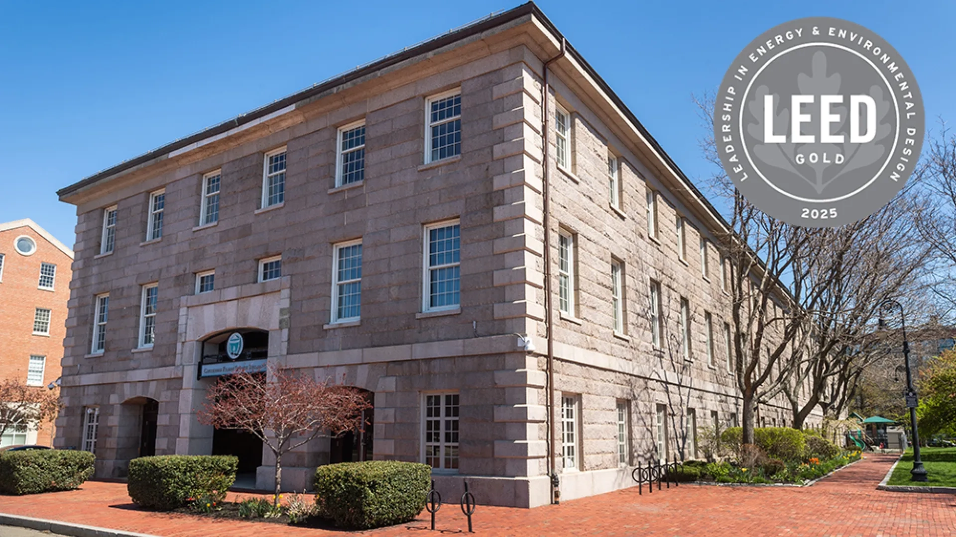 A stone building with a graphic that says LEED Gold 