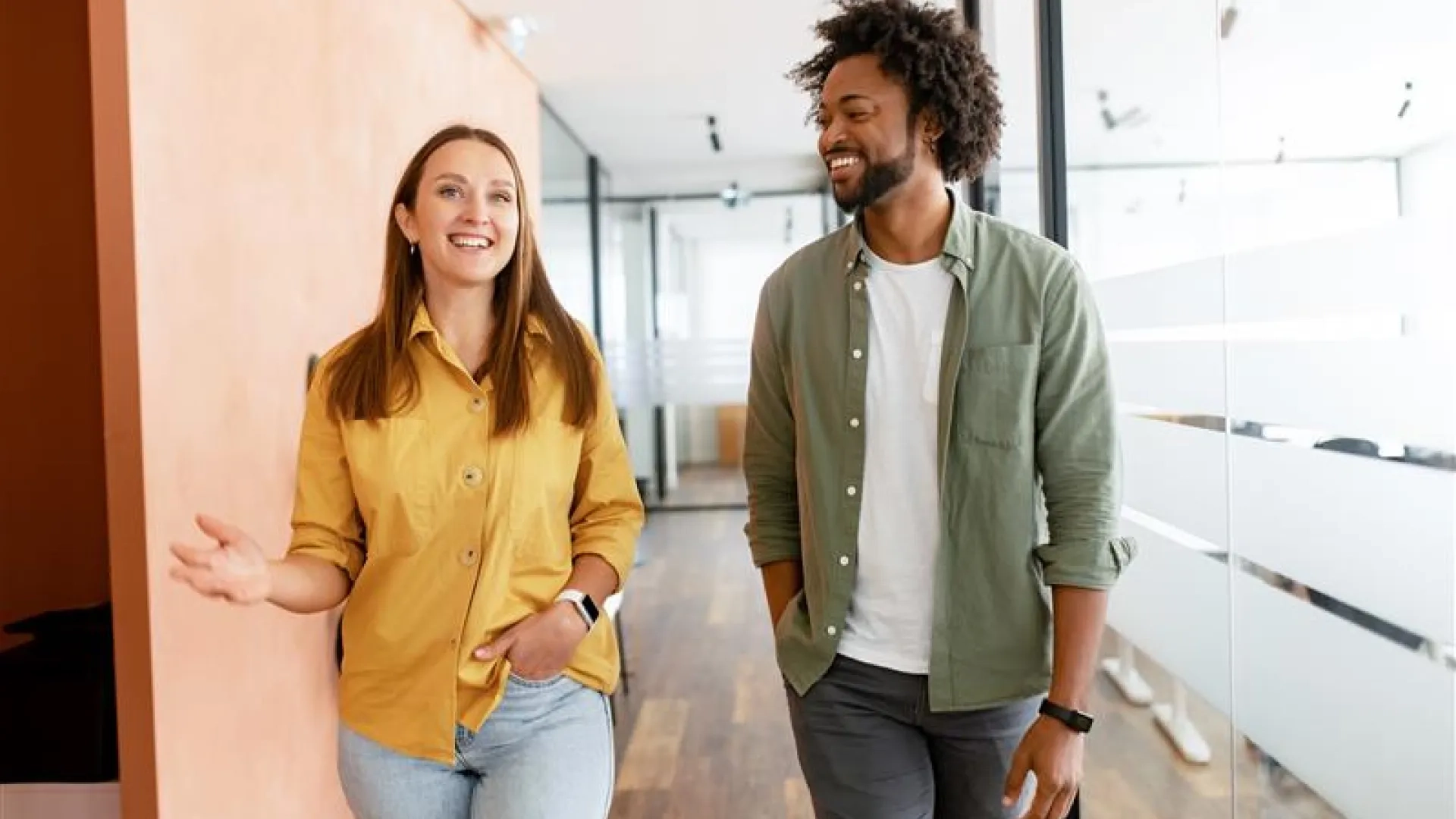 man and woman paraprofessional walk down a hallway