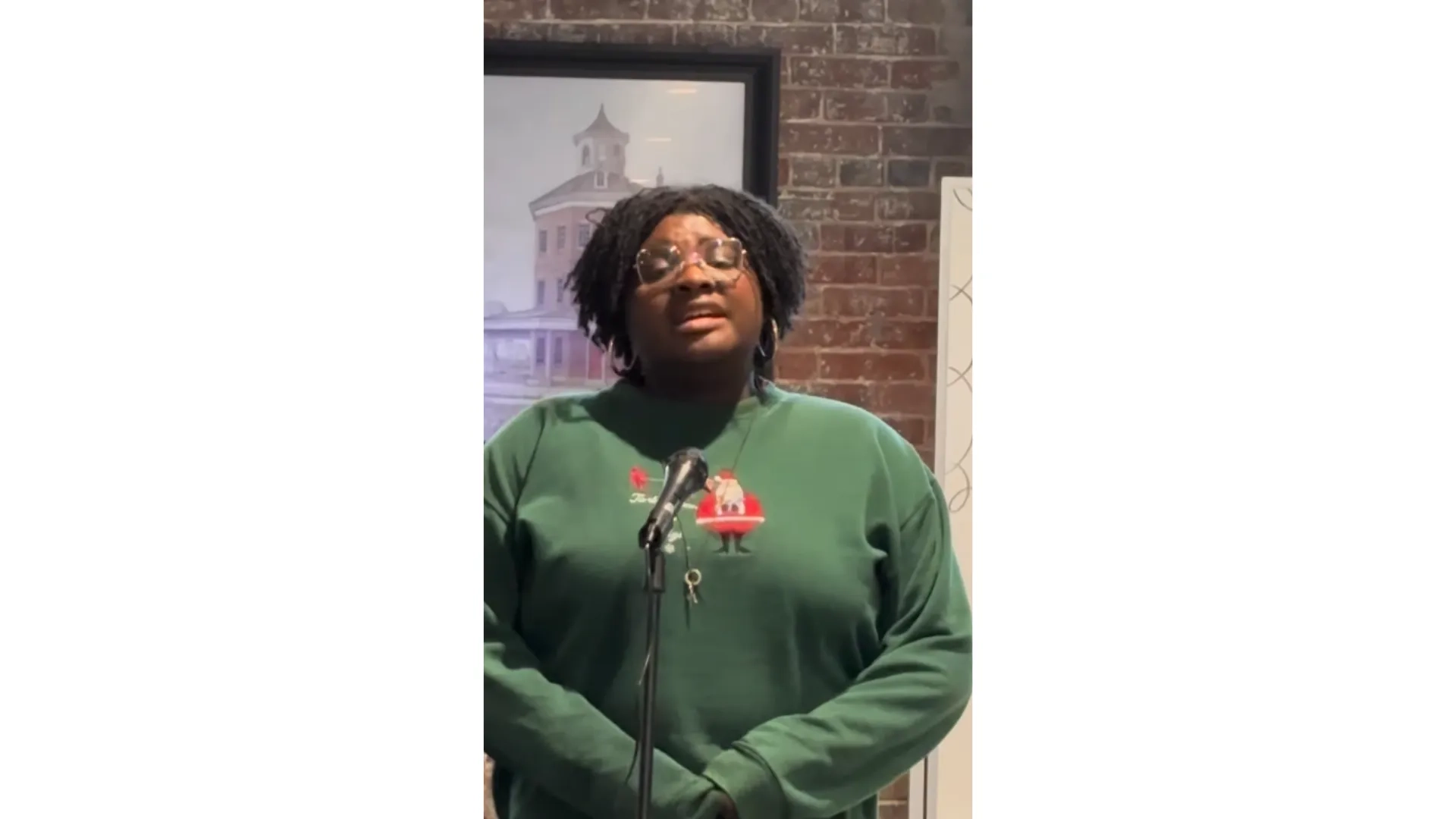 woman singing in green sweater