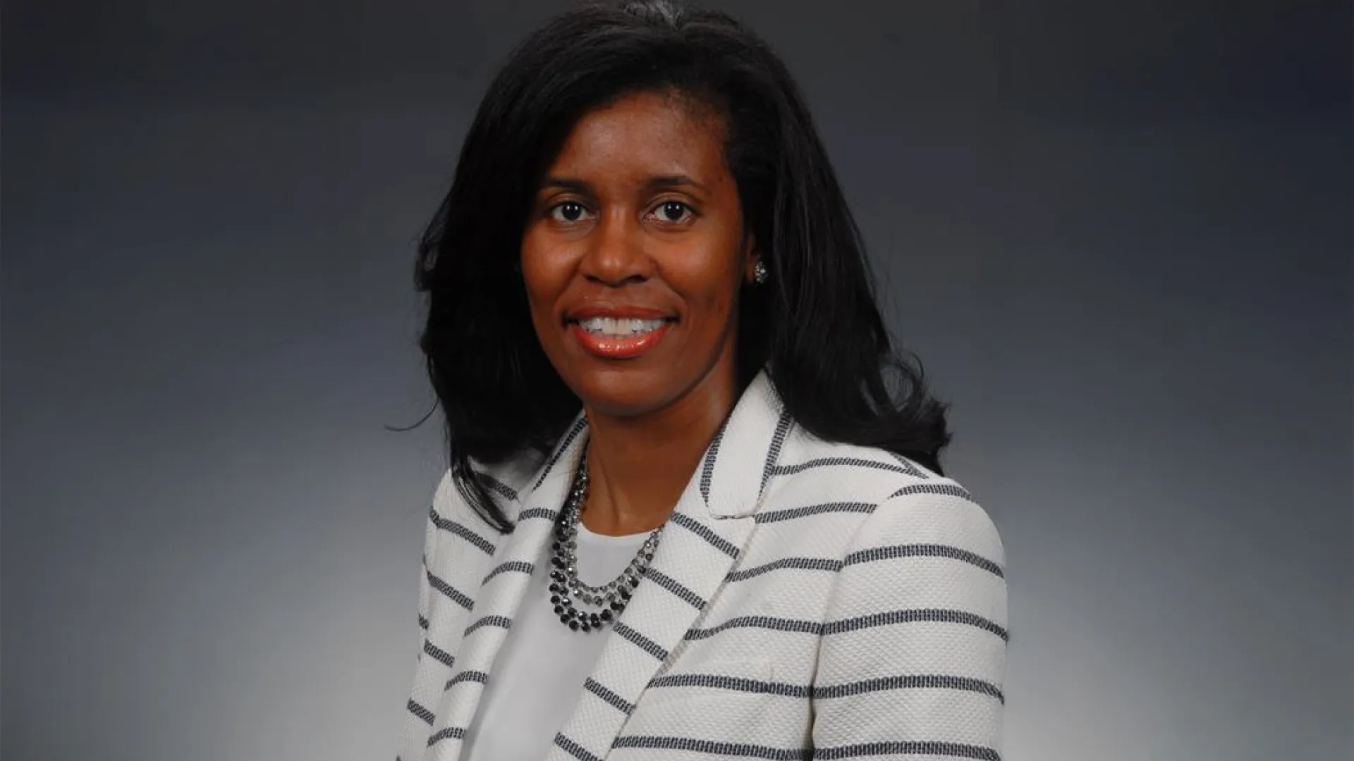 Professional headshot of woman in business attire