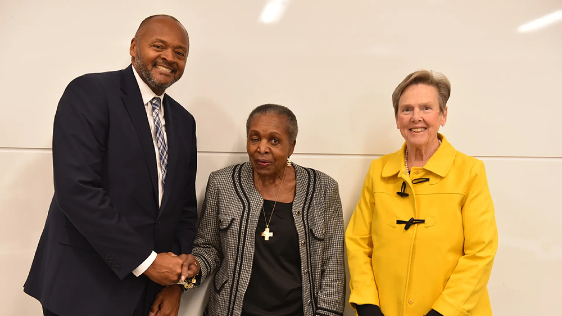 Three people pose for a photo