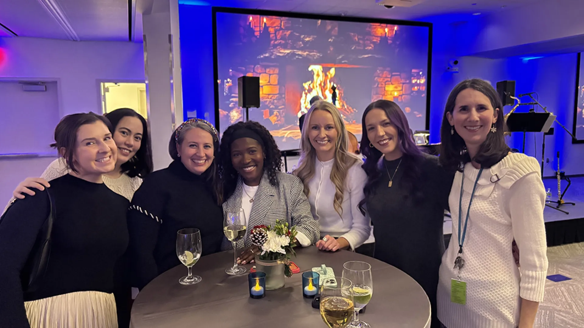 Seven people at a party pose for a photo