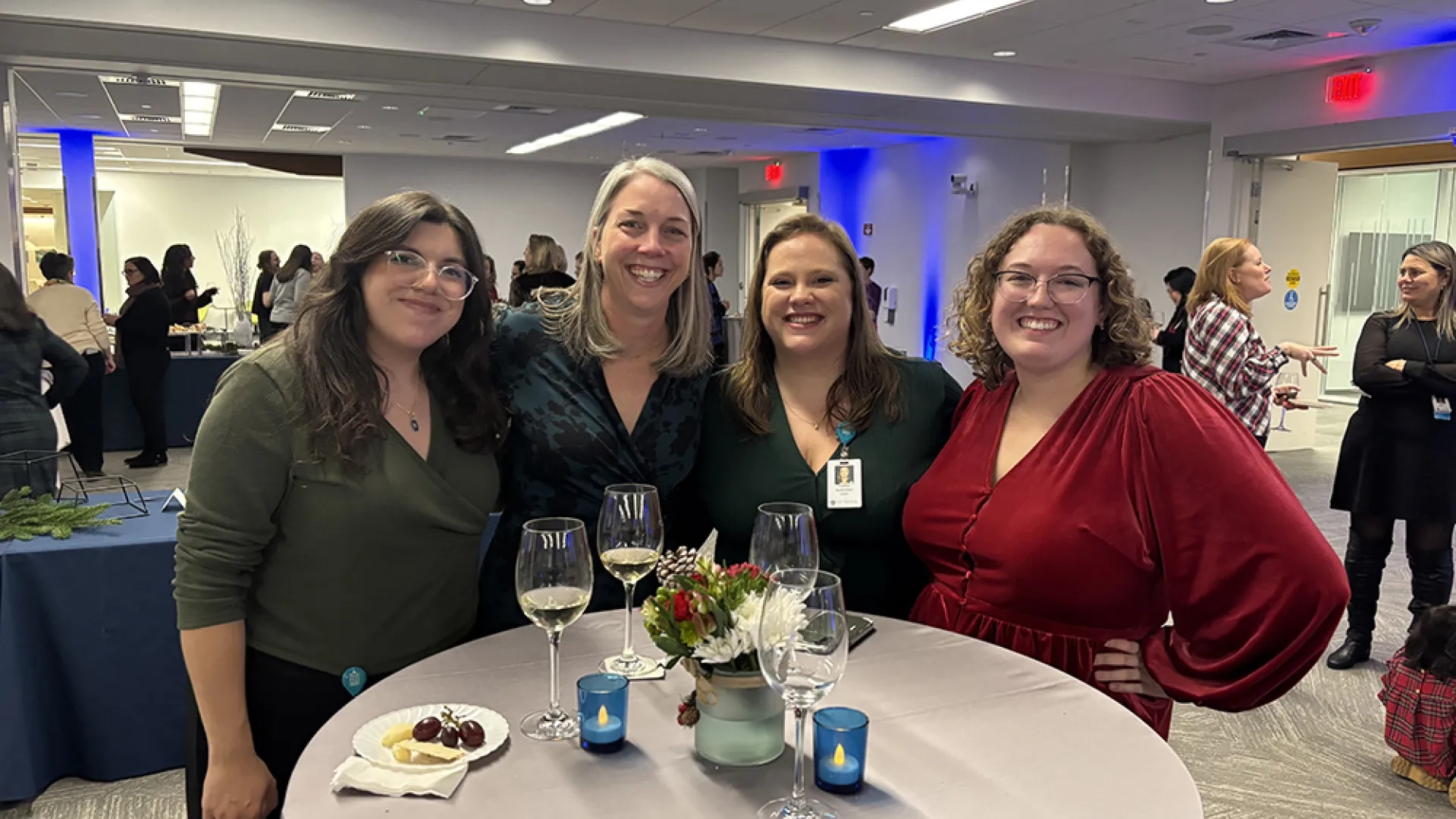Four people pose at a party