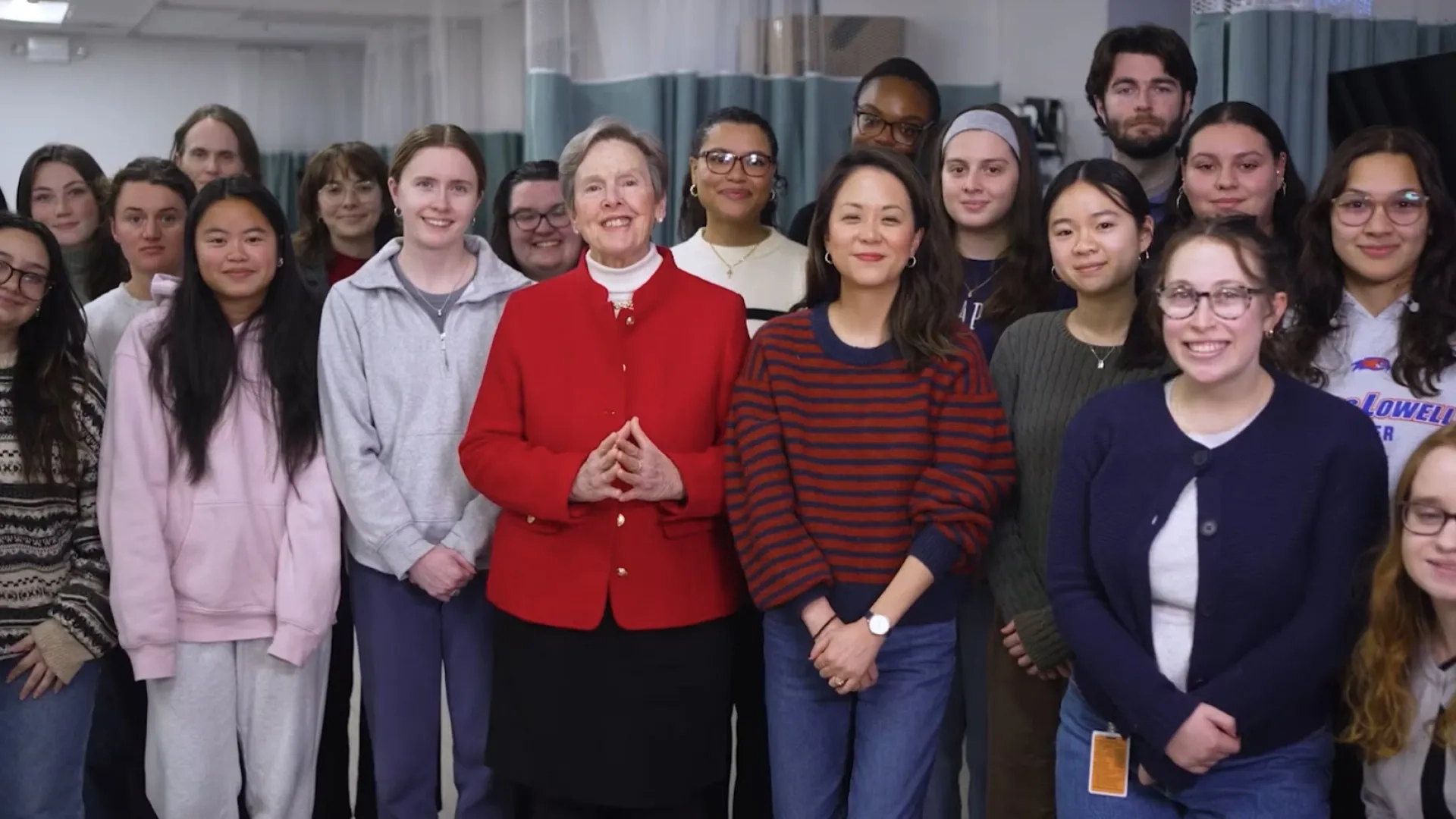 Our school president stands in front of a group of health professions students 