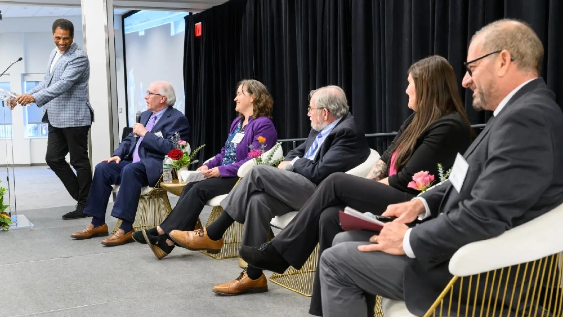 group of people sitting on a stage 