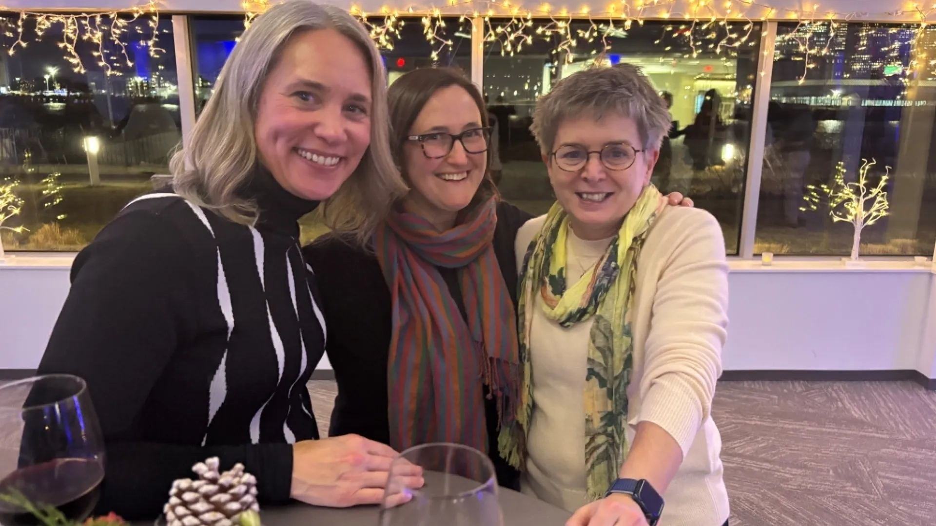 Three people at a table at a party
