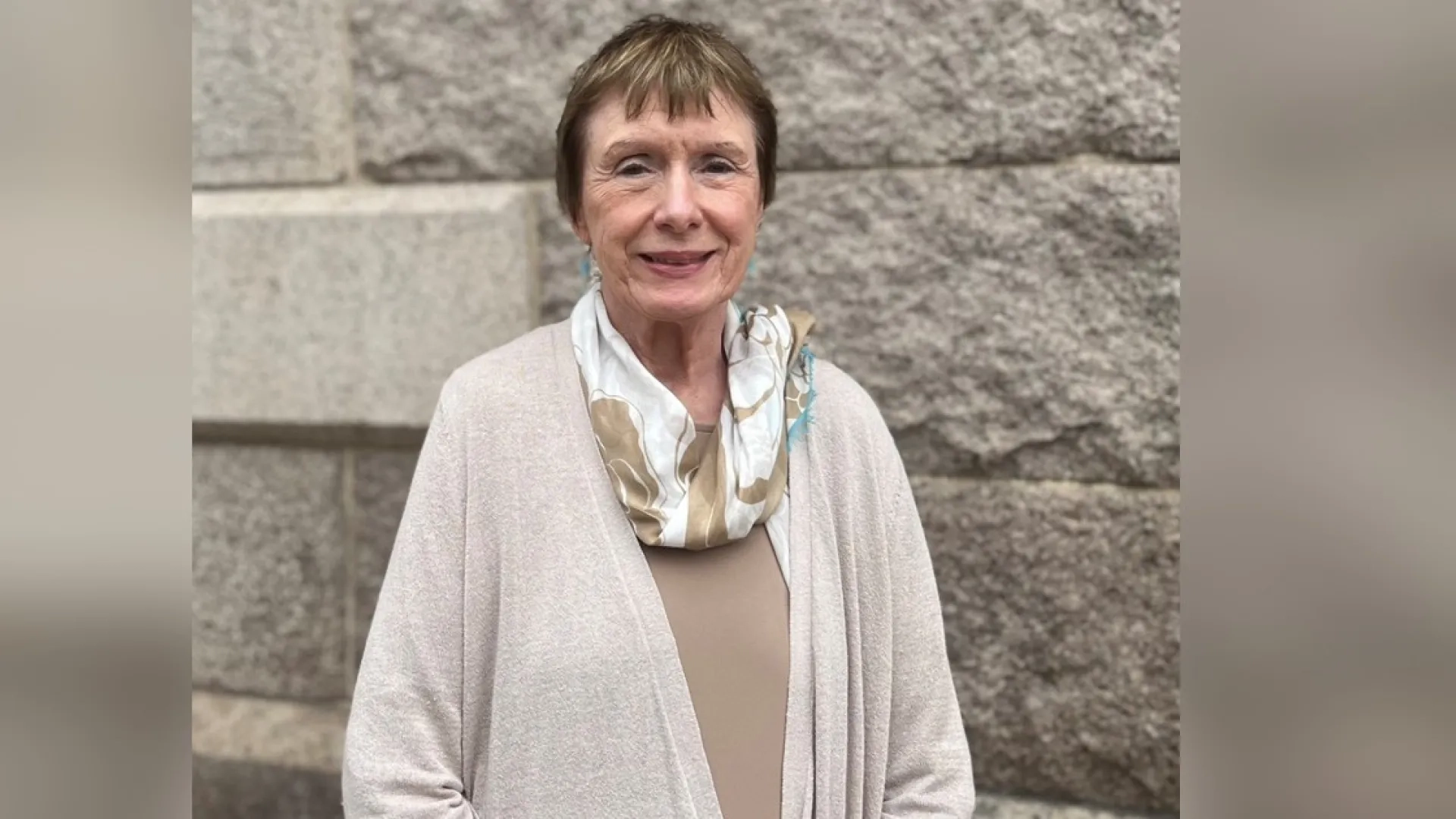woman in front of brick wall