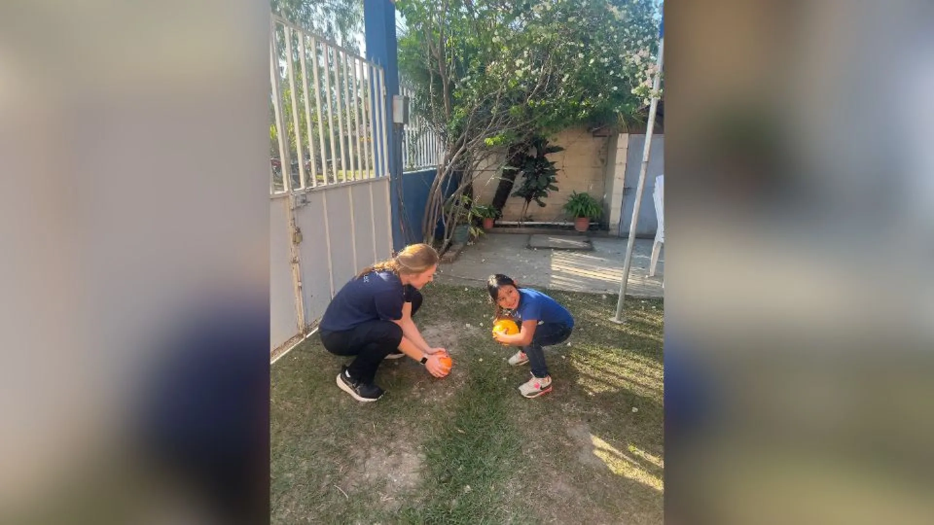 Girl playing with child outside