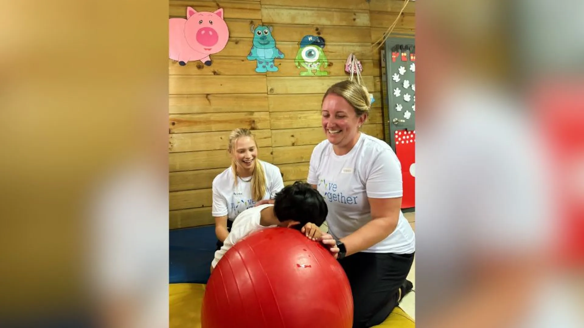 Two women helping child inside