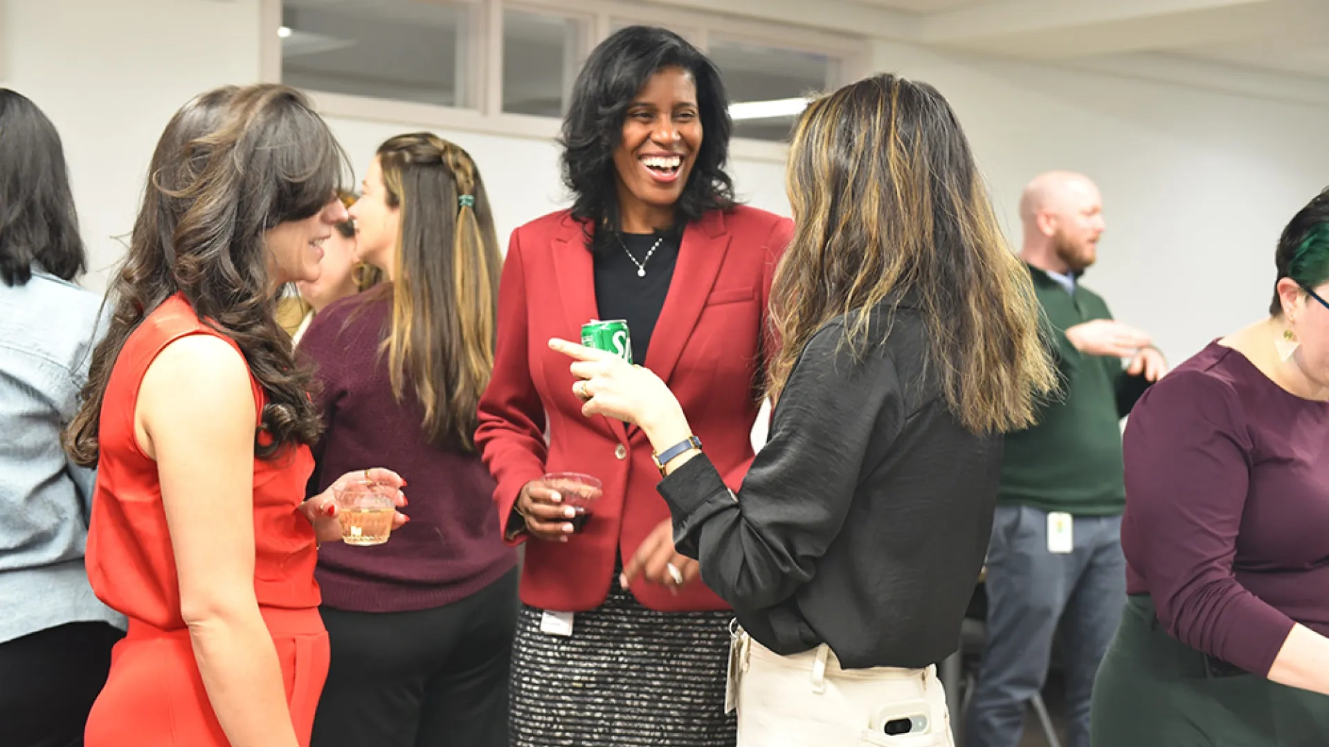 Three people stand talking to each other