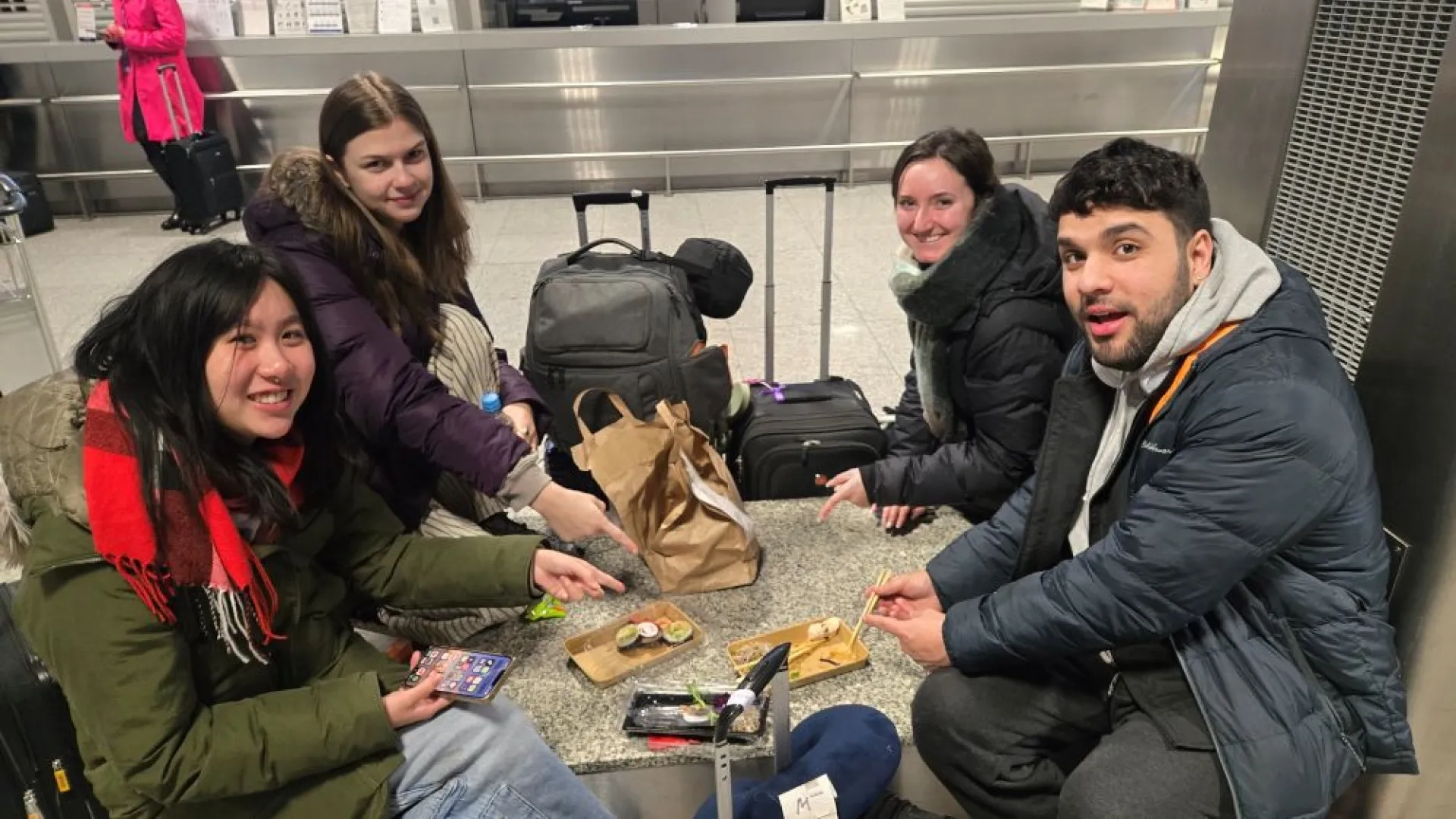4 students eating sushi