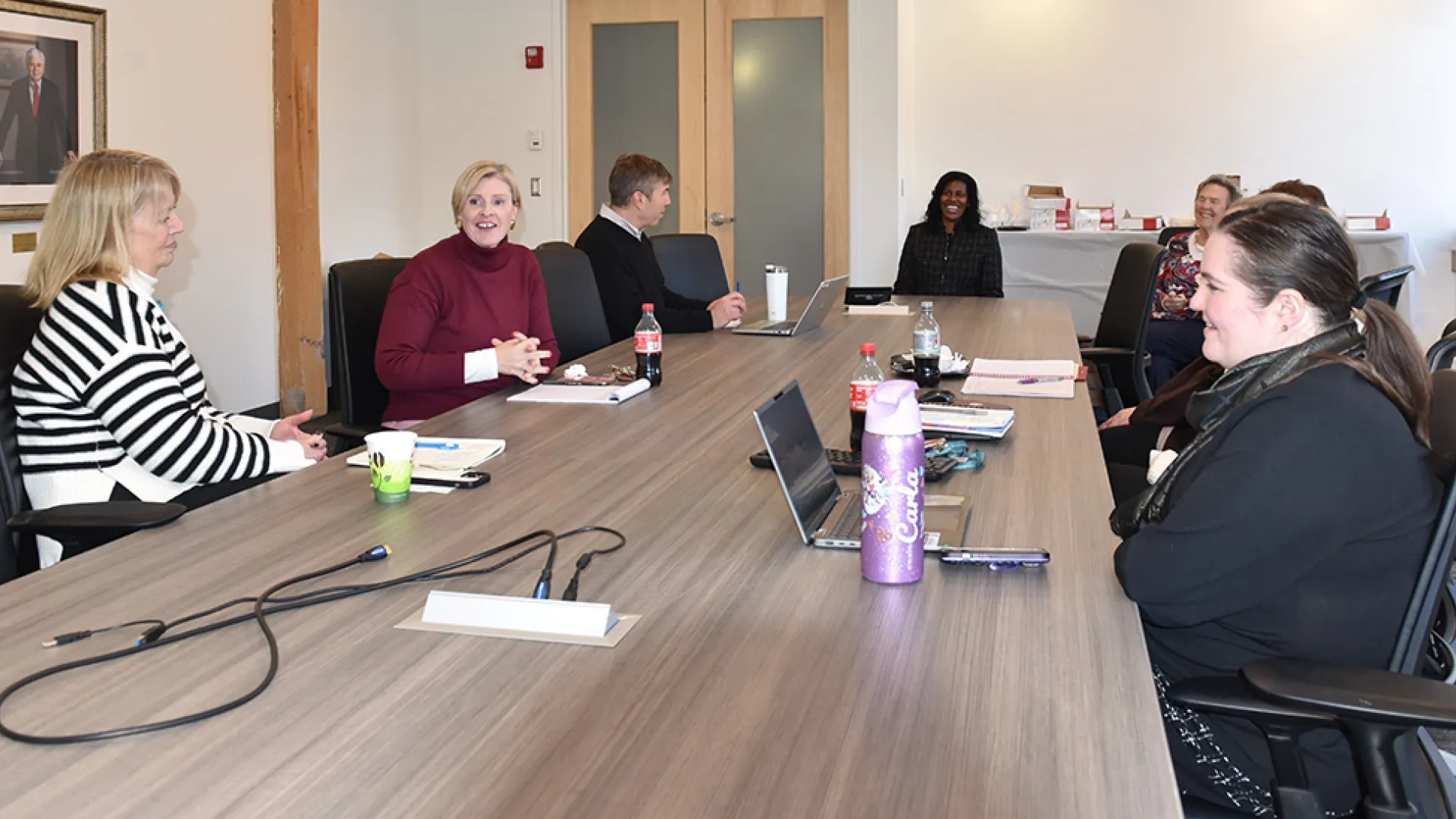 People sit around a conference table