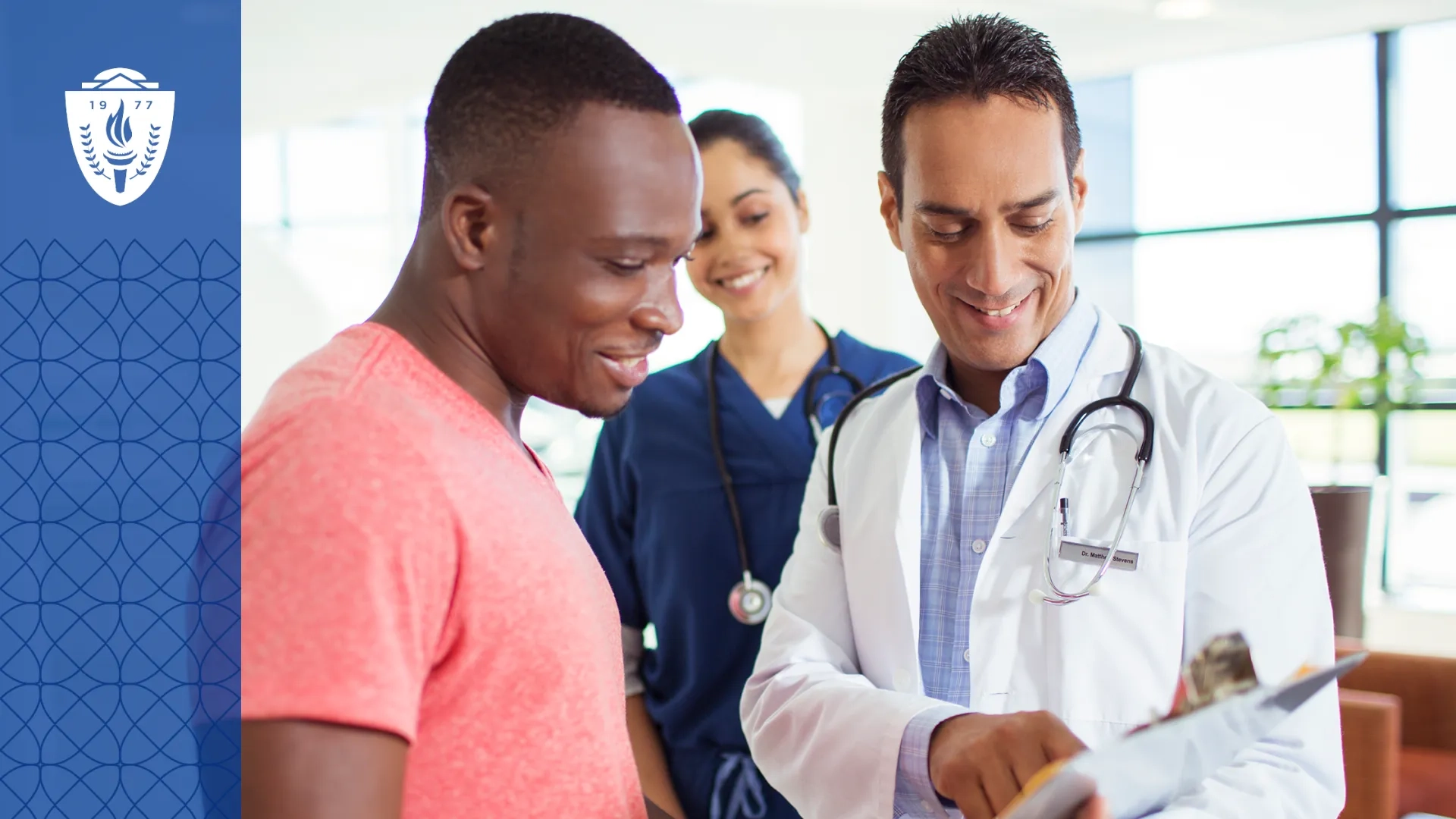 A doctor and patient stand in a room looking at information on a clipboard