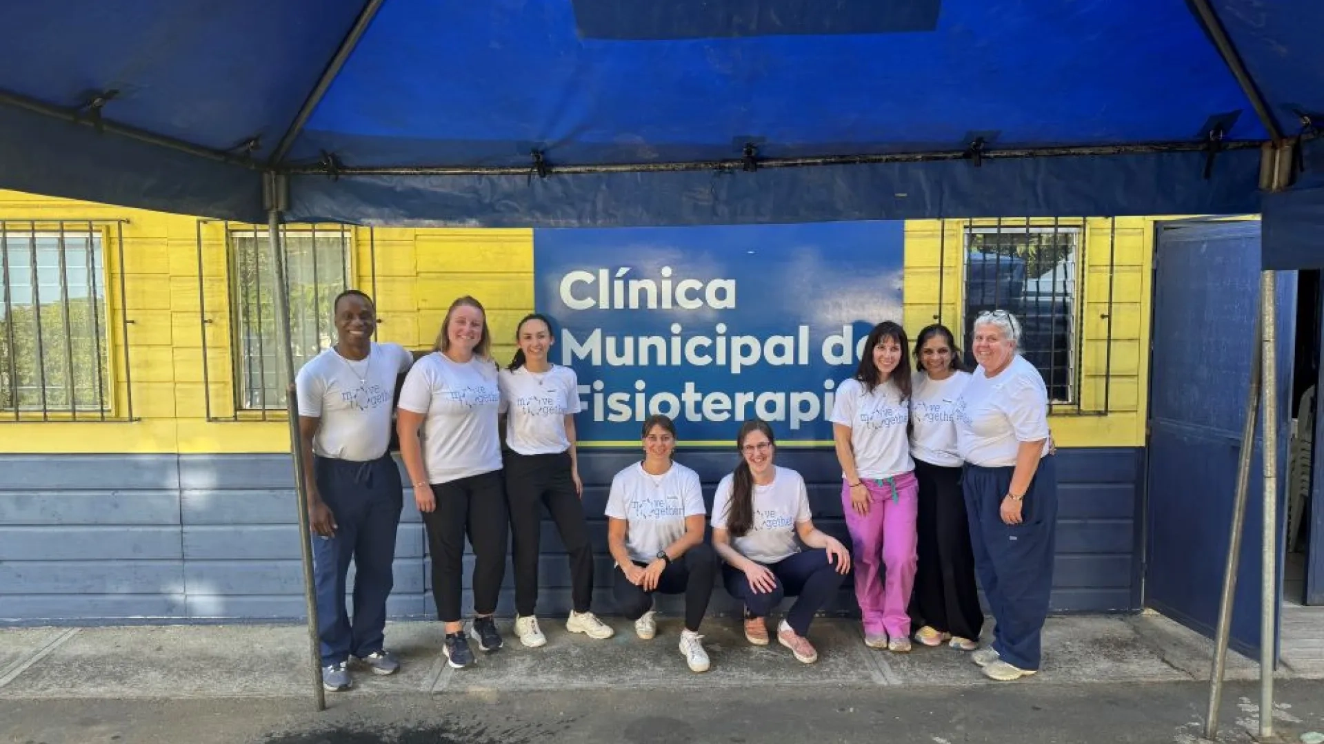 People posing in front of a clinic