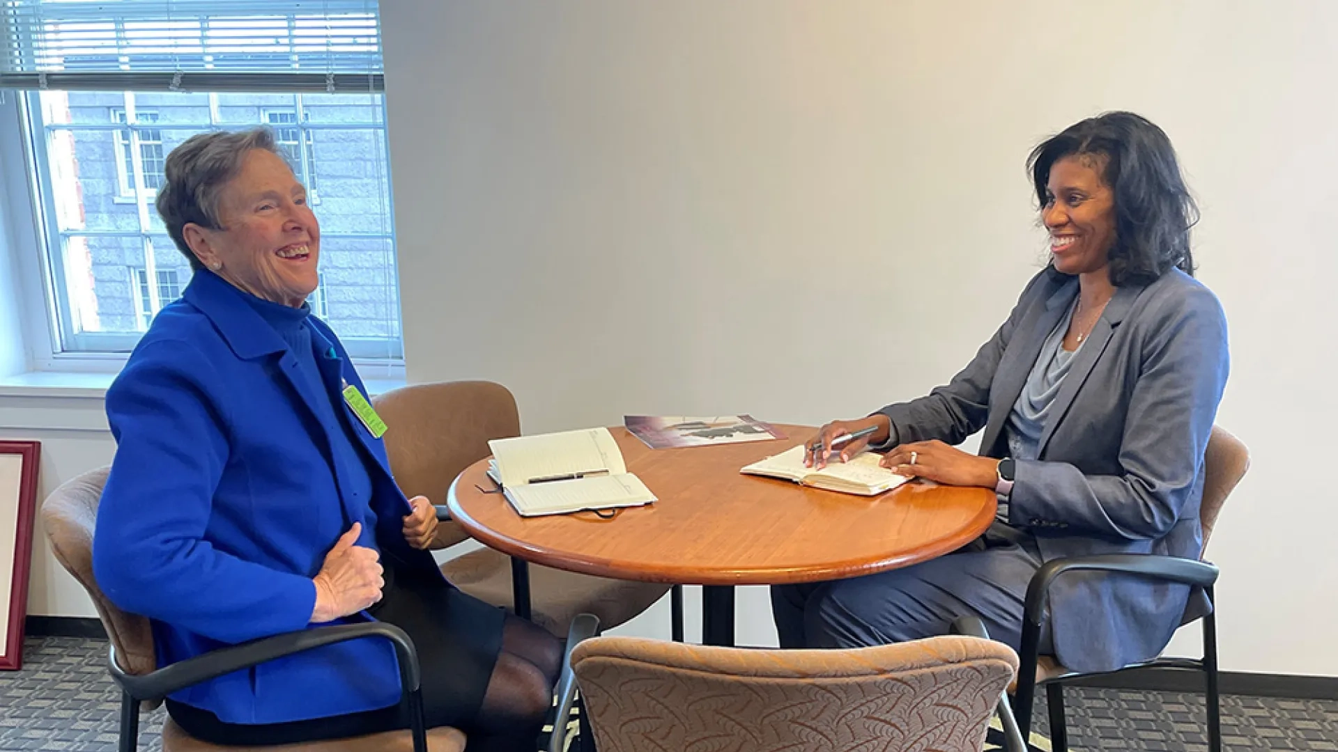 Two women sit at a table