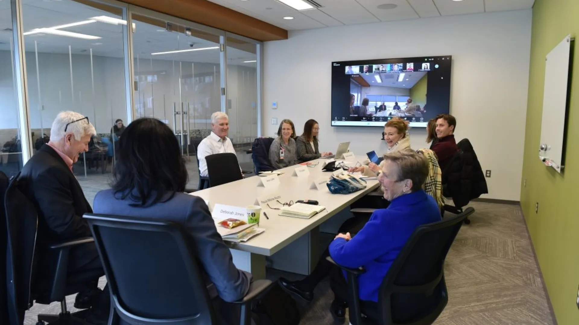 group of people smiling around a table