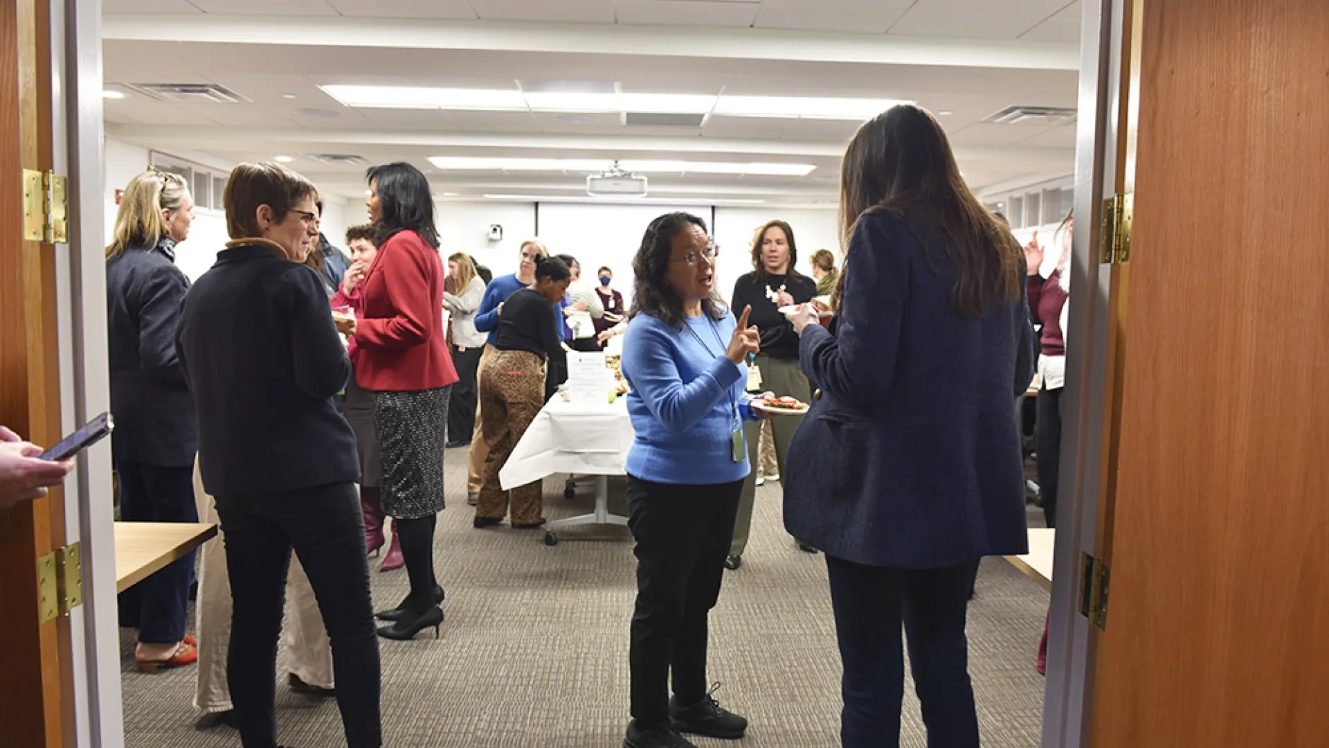 A room full of people at a social gathering