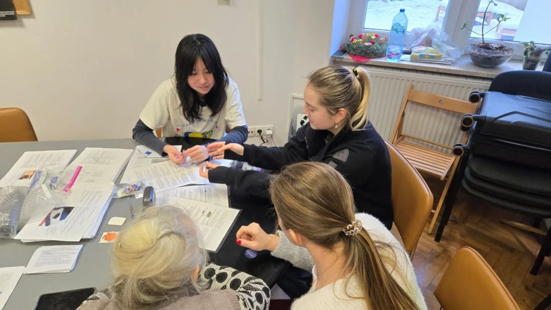 3 women around a table