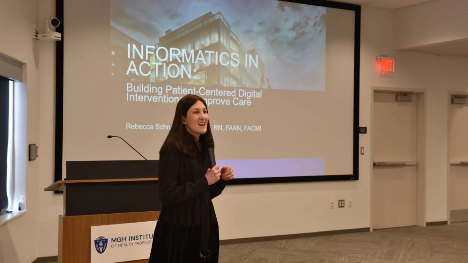 woman standing in front of a podium with a microphone