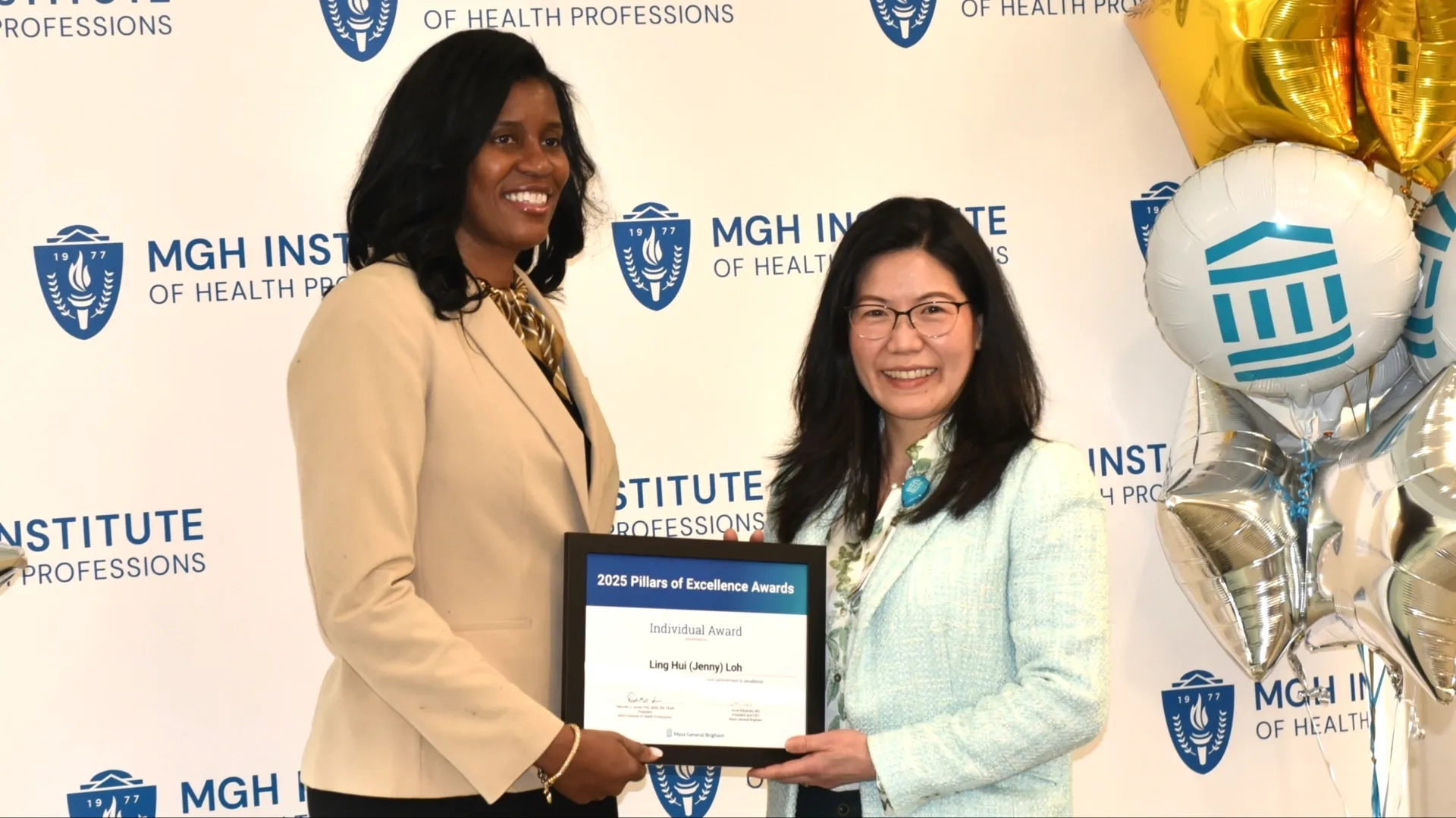 Two people posing for award photo