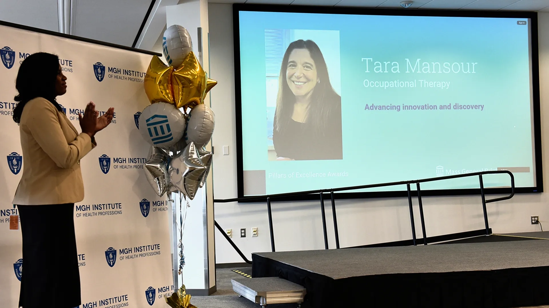 Two people posing for award photo