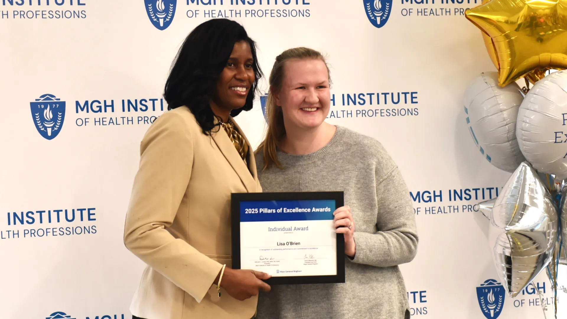 Two people posing for award photo