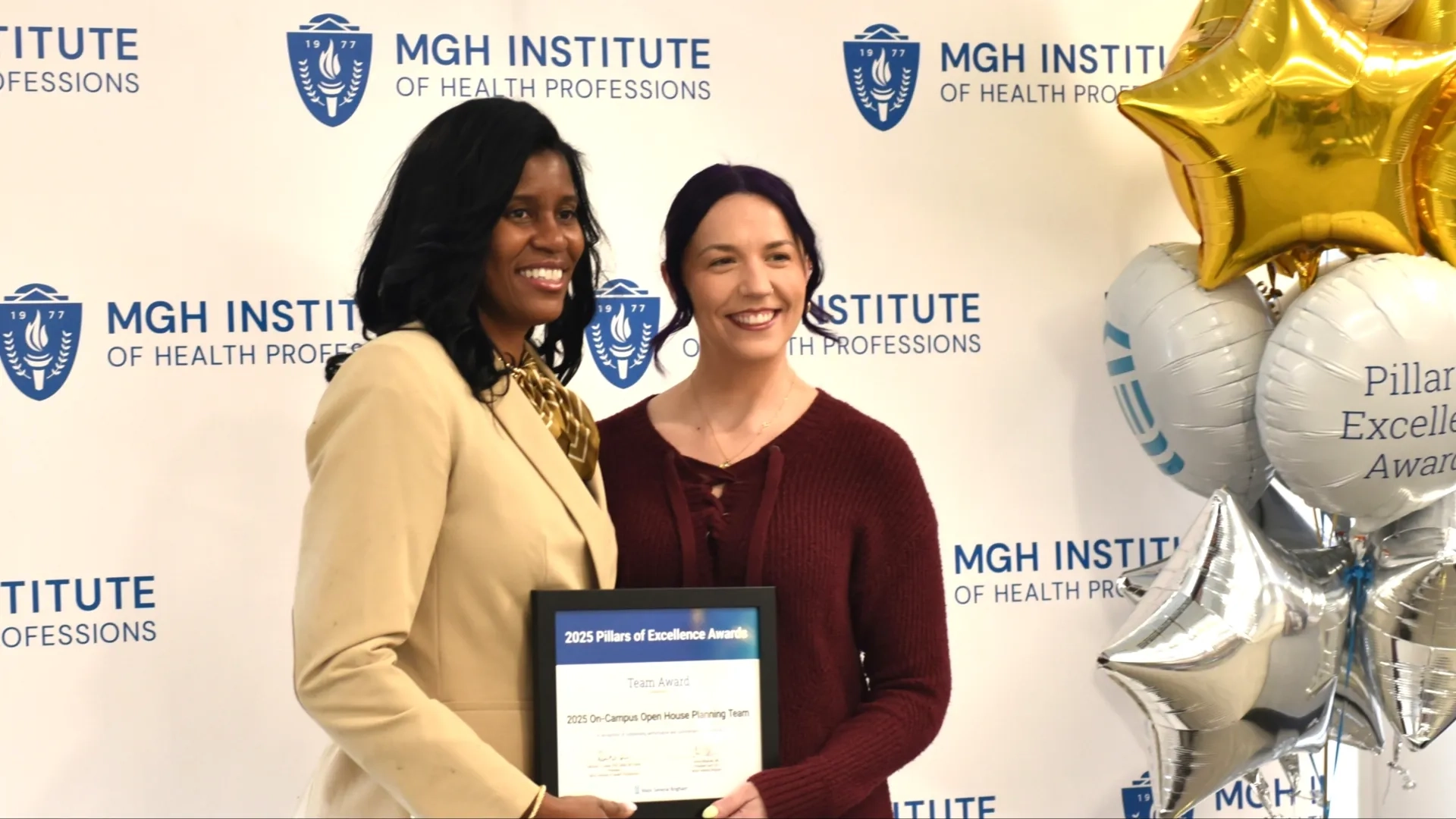 Two people posing for award photo
