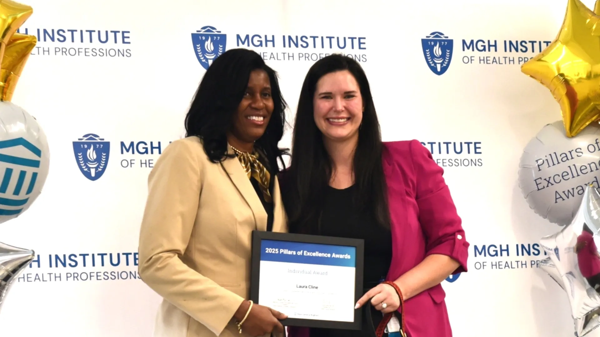 Two people posing for award photo