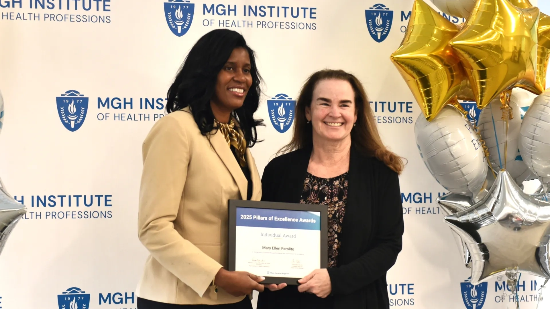 Two people posing for award photo