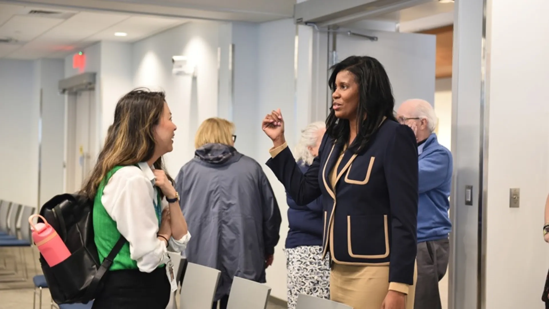 IHP President Deborah Jones speaking with a forum attendee