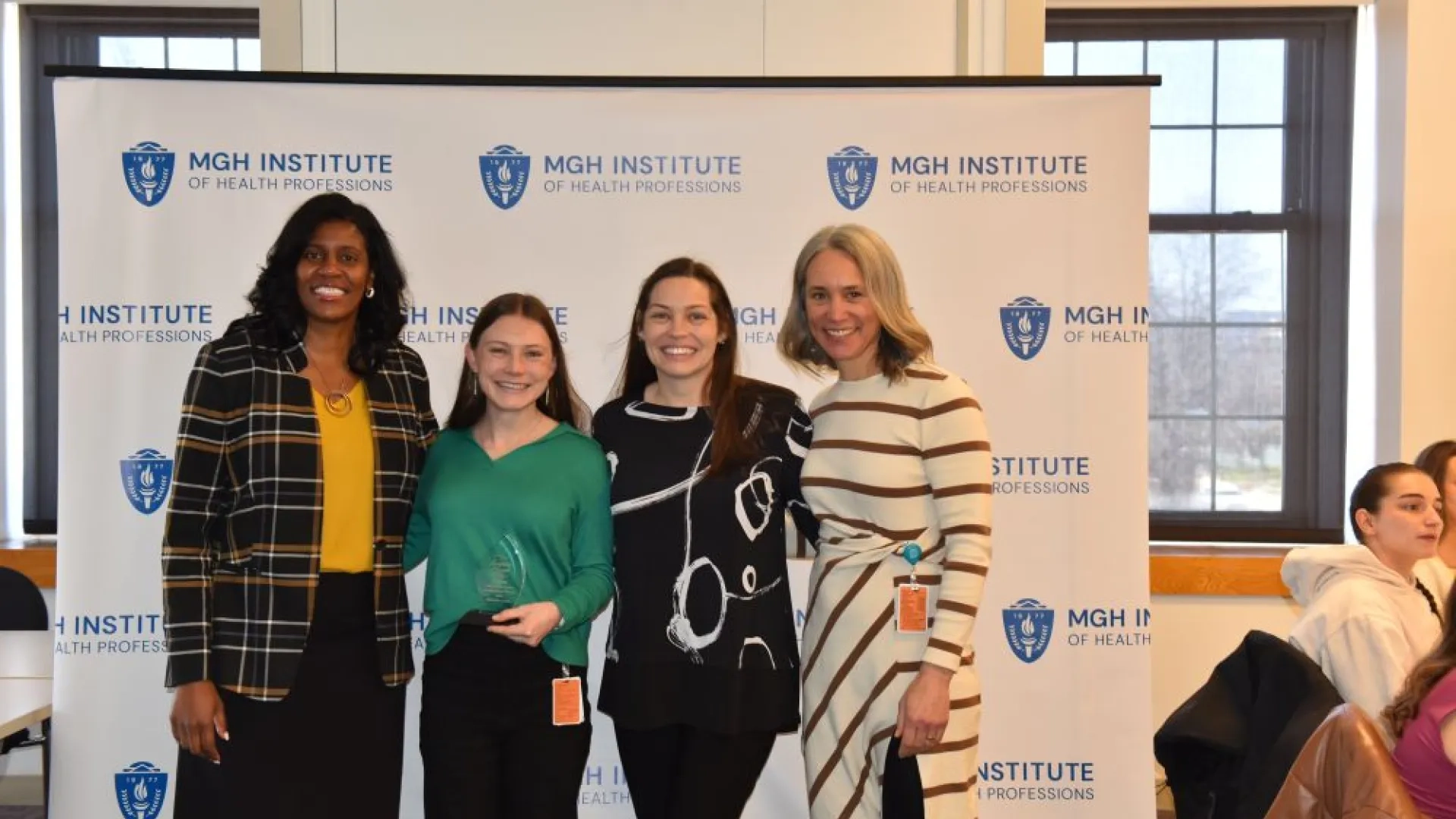 4 women posing i front of a backgrop