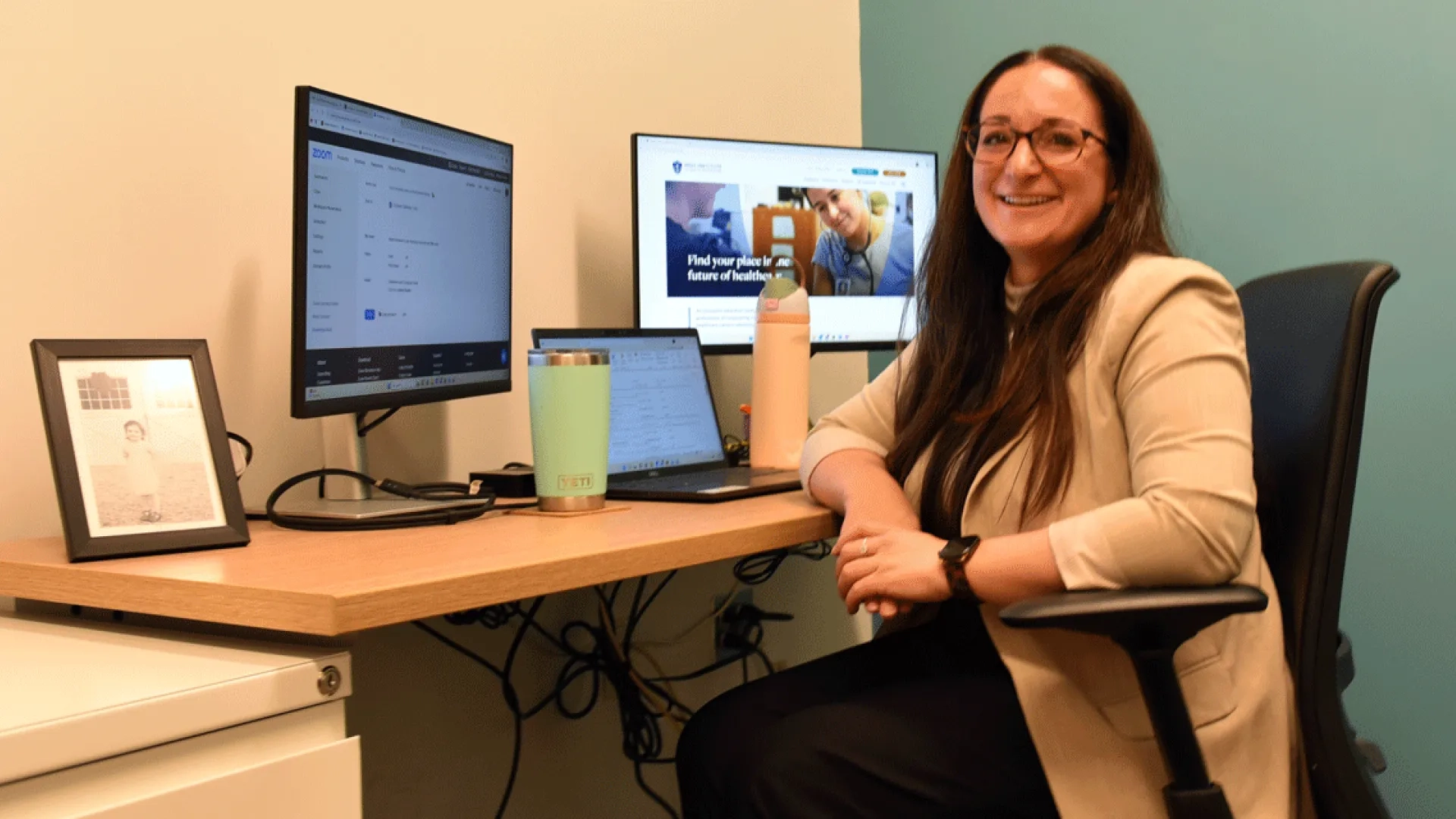 Lauren Finn sits at a desk in her office