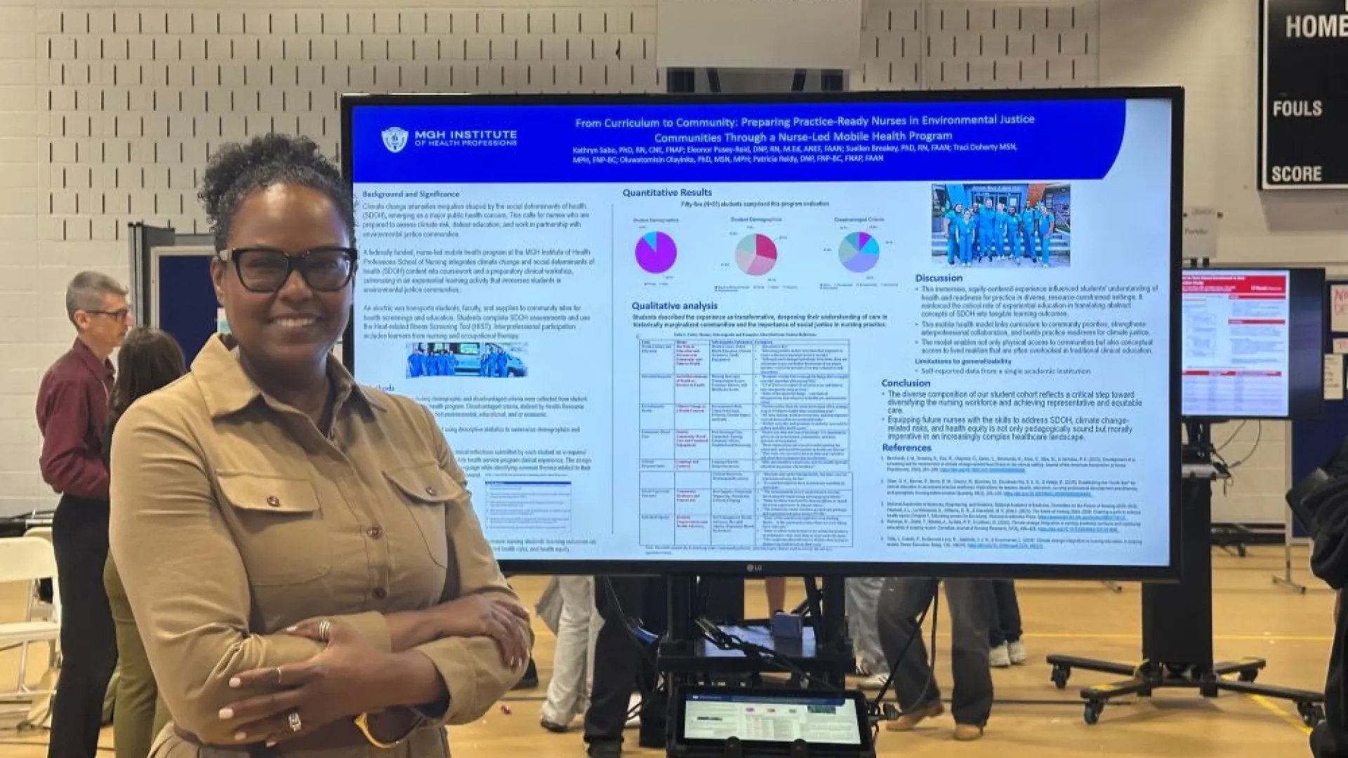 woman standing in front of a screen that has research data on it
