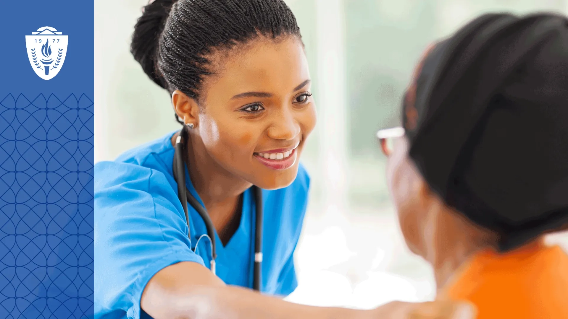 Nurse wearing blue scrubs and a stethoscope around neck putting her hand on shoulder of patient.