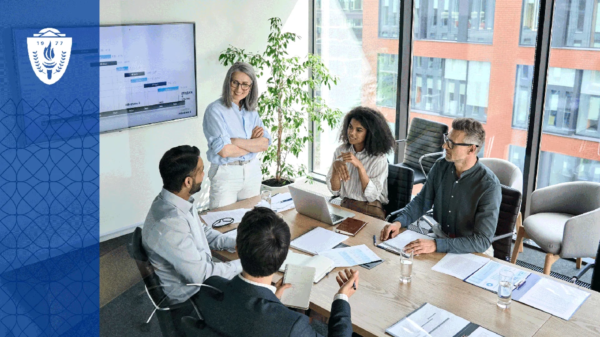 Faculty leaders from multiple health professions sit around a conference table discussing curriculum planning with dashboards, laptops, and educational materials visible. The environment should feel collaborative, strategic, and grounded in academic leadership. 