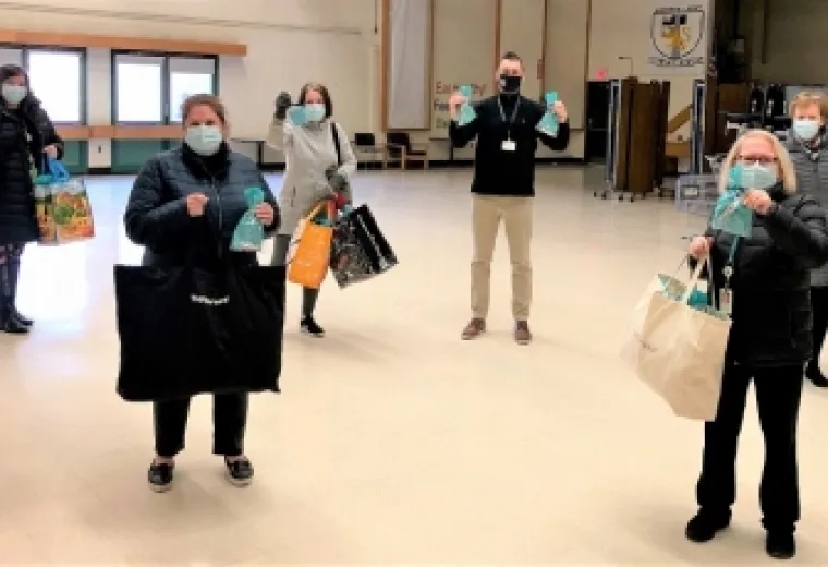 Harvard-Kent Elementary School Principal Jason Gallagher (fourth from left) received gift cards from (L-R) Carla Donati, Deb Kelly, Suellen Breakey, Patrice Nicholas, and Elaine Tagliareni of the MGH Institute’s School of Nursing.