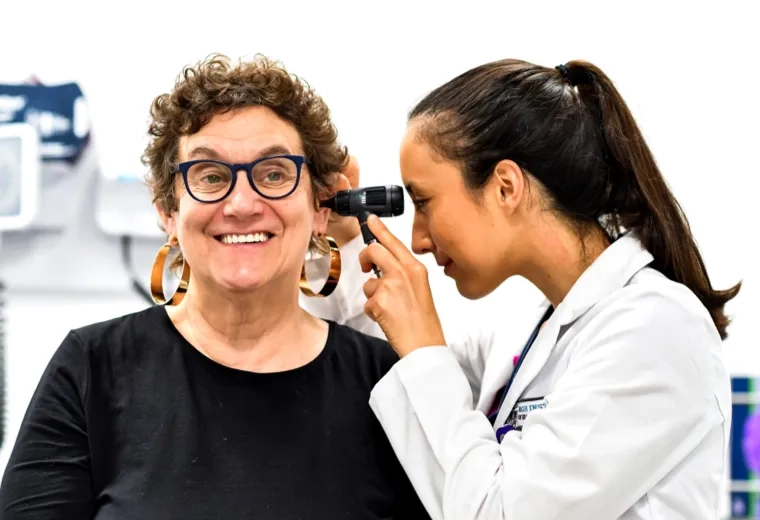Nurse looking into a patients ear 