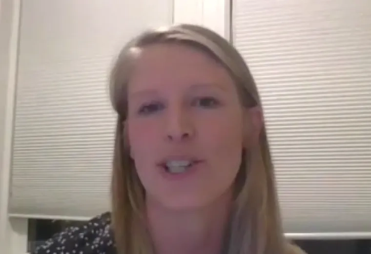 Dr. Margaret Brown in the center with window blinds in the background