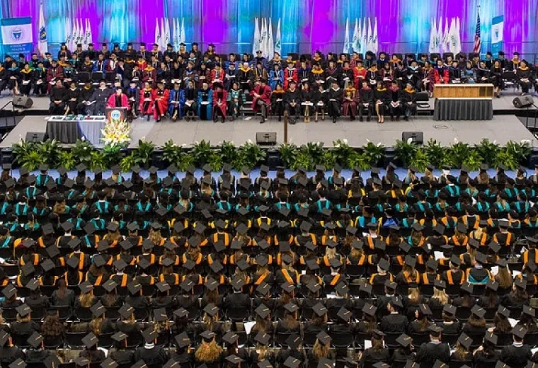 commencement audience aerial shot shows a sea of caps and gowns