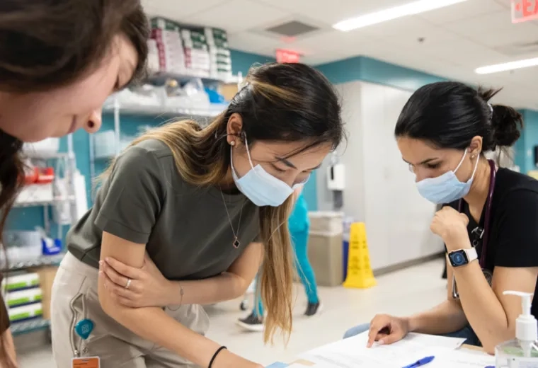 Three woman around a table studying
