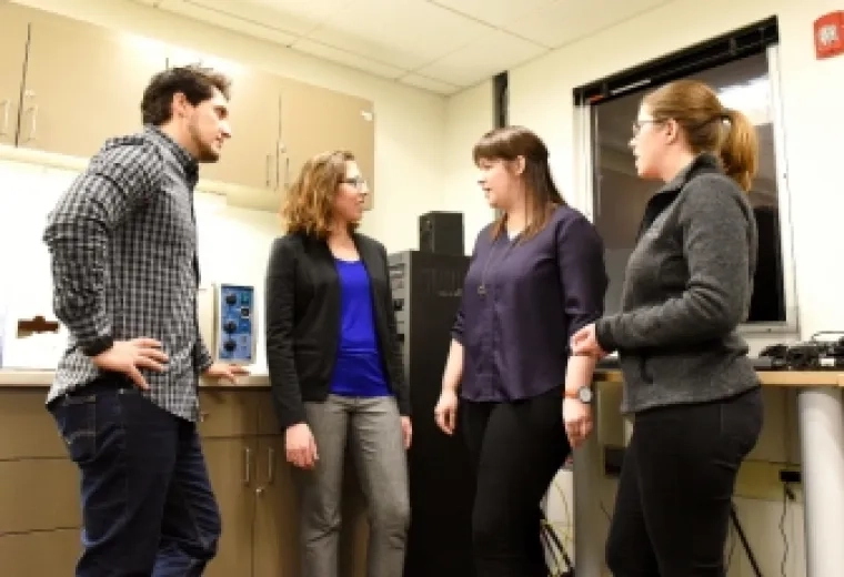Katie Stipancic, third from left, talks with fellow PhD students Paulo Teixeira, Megan Schliep, and Katherine Marks in the Center for Health and Rehabilitation Research.