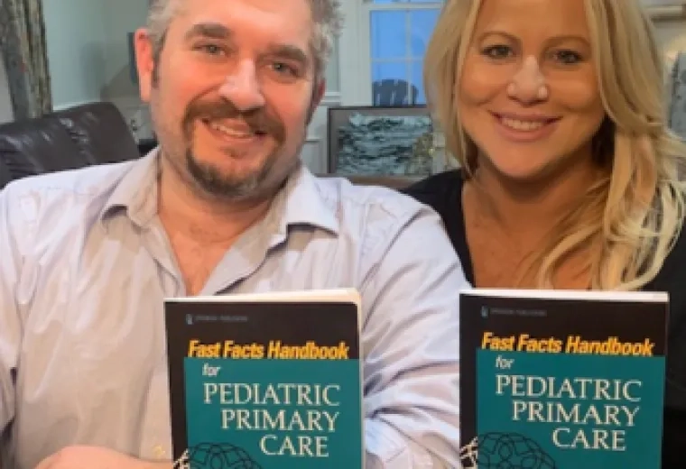 Mike and Kristine Ruggiero hold copies of their new textbook.