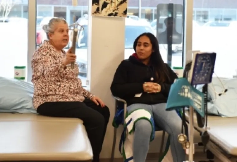 Jane Baldwin demonstrates PT equipment for the MGH Youth Scholars.
