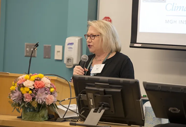 A woman speaking on a microphone