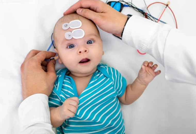 An audiologist conducting a hearing assessment on an infant, demonstrating the MGH IHP Doctor of Audiology program's focus on clinical expertise.