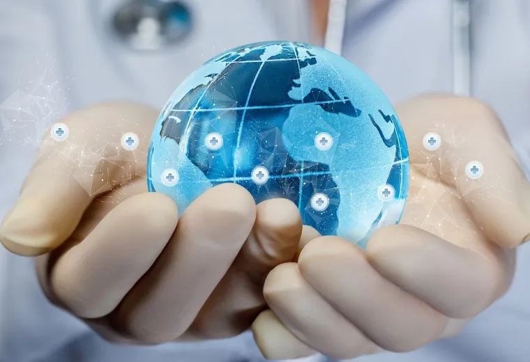 a blue glass globe is held in two white latex gloved hands