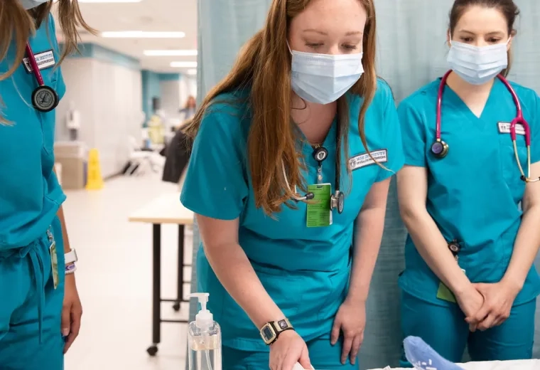 Three students working in the simulation lab.