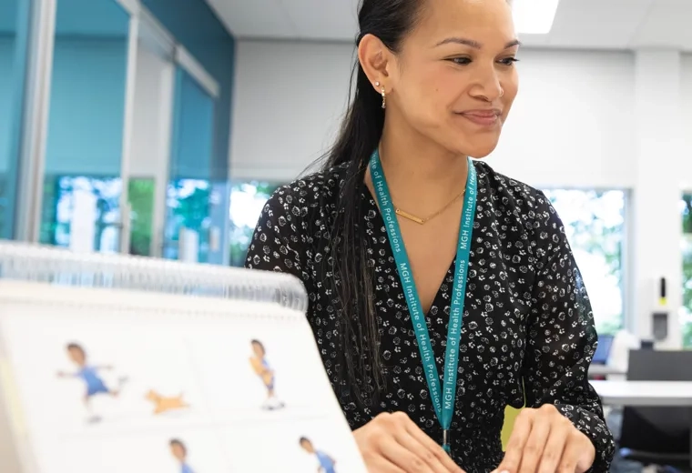 A woman smiling looking off to the side