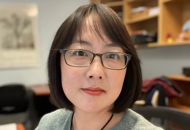 Wei Zhang in grey sweater