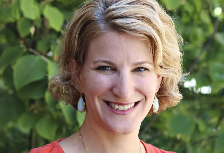 Headshot of an MGH IHP faculty member for the Doctor of Audiology program, outdoors with a natural background.